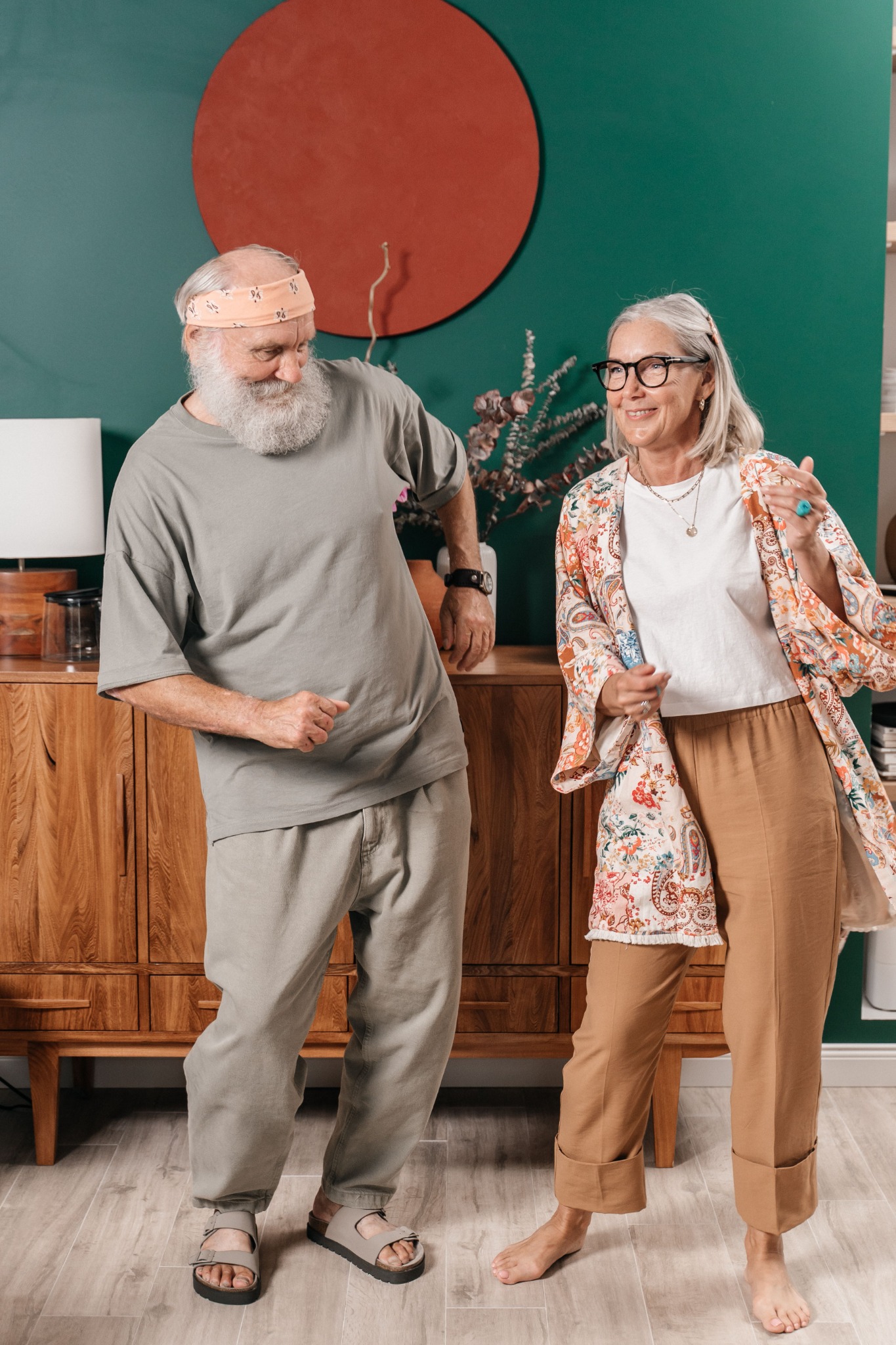 An older couple dancing together at home